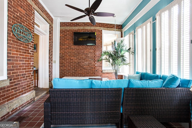 unfurnished sunroom featuring ceiling fan