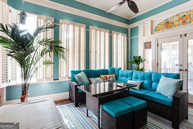 sunroom / solarium with ceiling fan and french doors