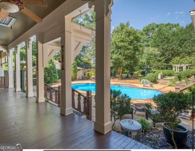 view of swimming pool featuring ceiling fan