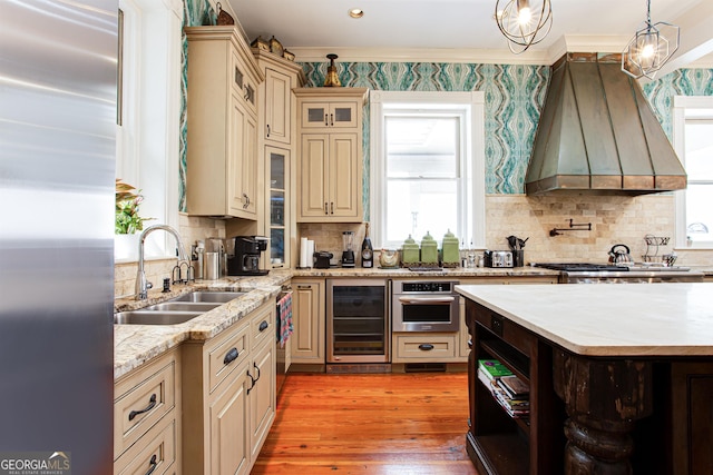 kitchen featuring decorative light fixtures, tasteful backsplash, wine cooler, stainless steel appliances, and premium range hood