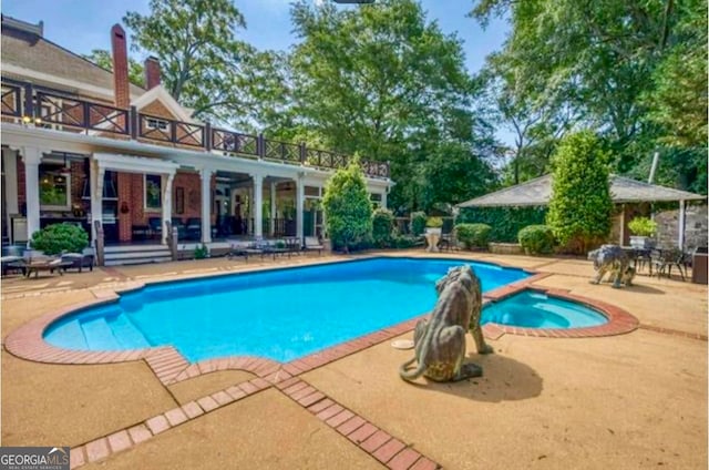 view of swimming pool with a patio area