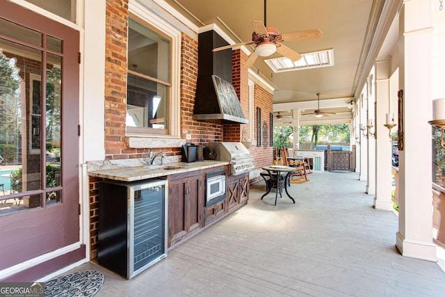 view of patio / terrace with ceiling fan, sink, area for grilling, and exterior kitchen