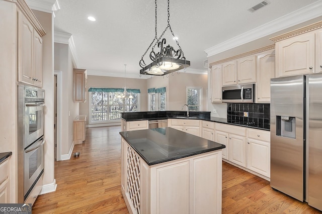 kitchen with backsplash, light hardwood / wood-style flooring, appliances with stainless steel finishes, and plenty of natural light