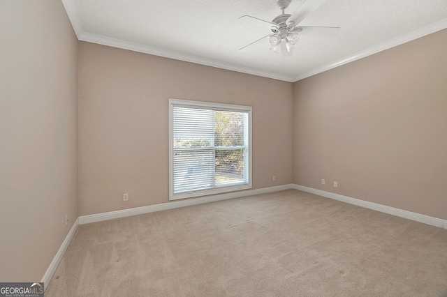 carpeted empty room with ceiling fan and crown molding