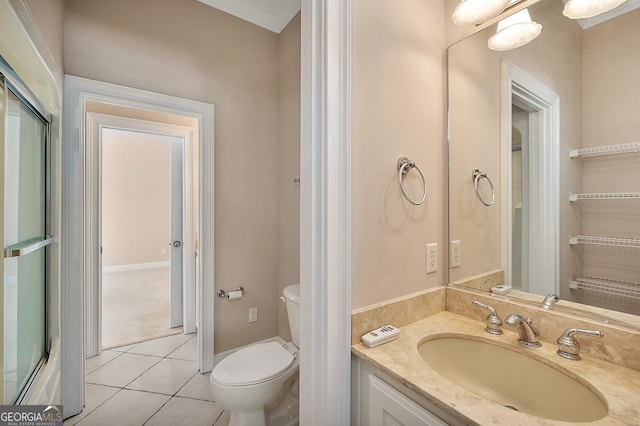 bathroom featuring toilet, vanity, and tile flooring