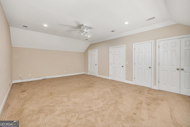 additional living space with light carpet, a textured ceiling, ceiling fan, and lofted ceiling