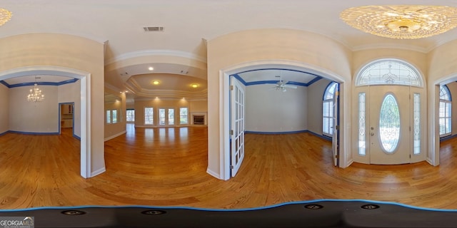 entryway with hardwood / wood-style floors and ceiling fan with notable chandelier