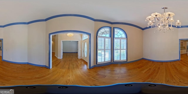 foyer with a chandelier and crown molding