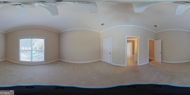 unfurnished room with carpet floors and vaulted ceiling