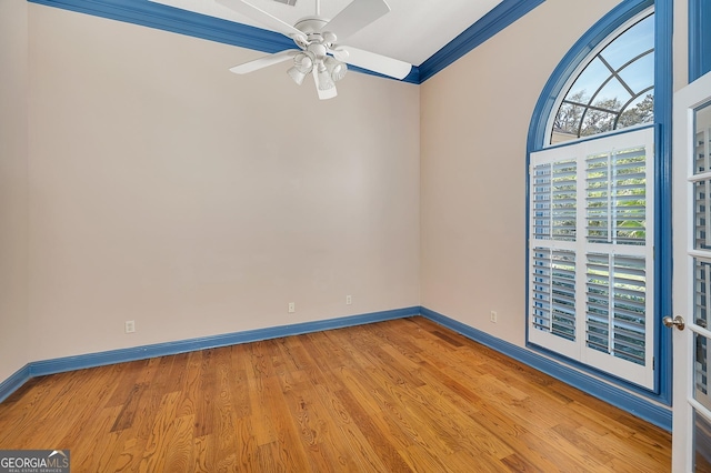 empty room with crown molding, light hardwood / wood-style floors, and ceiling fan