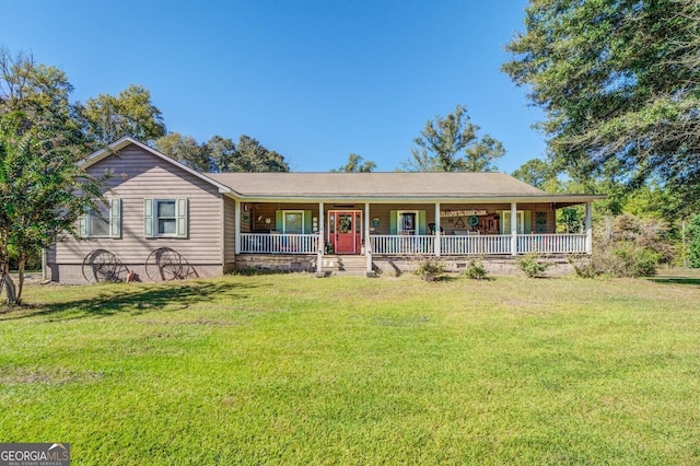 ranch-style home featuring covered porch and a front lawn