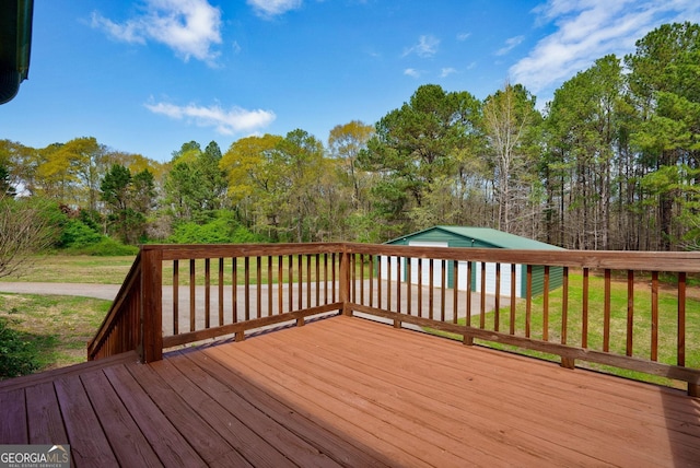 wooden terrace with a lawn