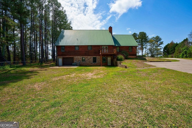 exterior space featuring a lawn and a garage