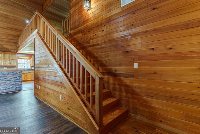 staircase featuring wood ceiling, wooden walls, and dark wood-type flooring