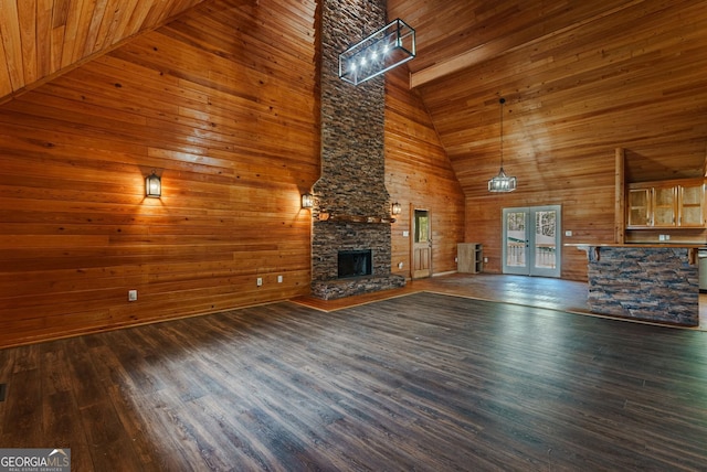 unfurnished living room featuring wooden walls, wooden ceiling, high vaulted ceiling, and dark hardwood / wood-style flooring