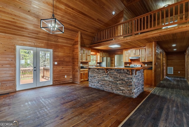 kitchen with high vaulted ceiling, dark hardwood / wood-style flooring, and french doors