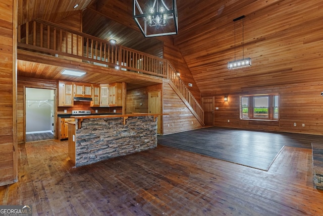 kitchen featuring high vaulted ceiling, dark hardwood / wood-style flooring, a notable chandelier, and decorative light fixtures