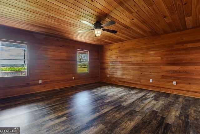 unfurnished room featuring dark hardwood / wood-style floors, wood ceiling, and ceiling fan