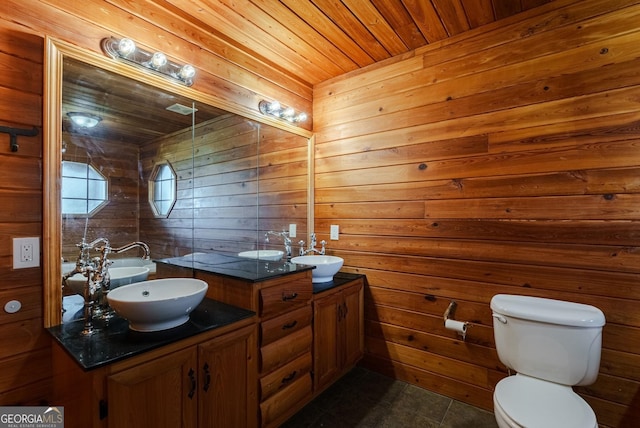 bathroom featuring tile flooring, wooden walls, toilet, wooden ceiling, and double sink vanity