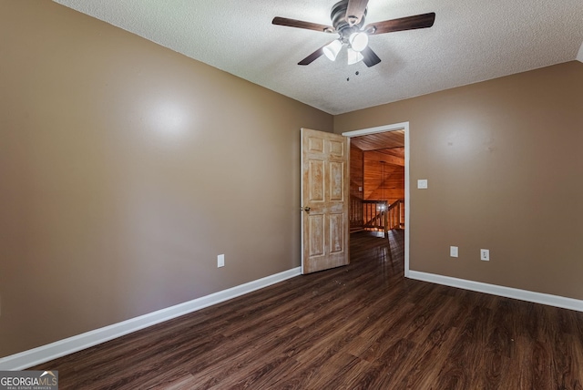 spare room featuring ceiling fan, a textured ceiling, and dark hardwood / wood-style flooring