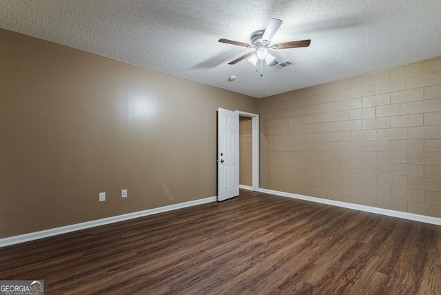 spare room with dark hardwood / wood-style flooring, a textured ceiling, and ceiling fan