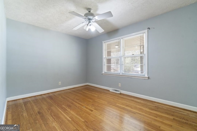 empty room featuring a textured ceiling, ceiling fan, and light hardwood / wood-style flooring