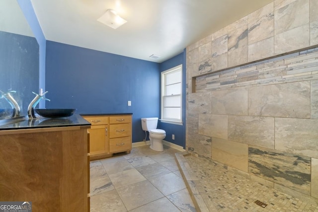 interior space featuring tile floors, toilet, and vanity