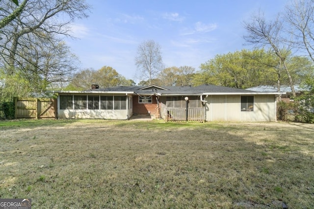 rear view of property with a yard