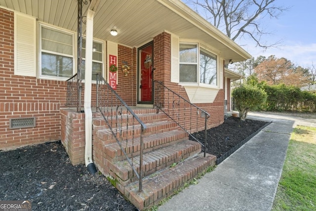 view of exterior entry with a porch