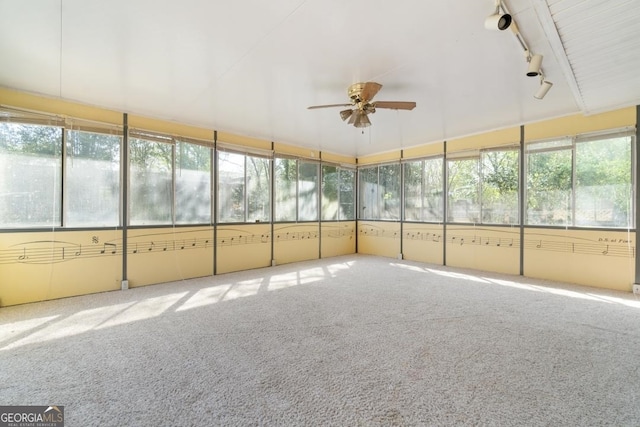 unfurnished sunroom featuring plenty of natural light, vaulted ceiling, ceiling fan, and track lighting