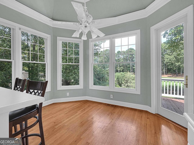 sunroom featuring ceiling fan