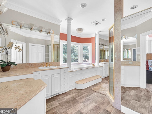 bathroom with ornamental molding, vanity, plus walk in shower, and ornate columns