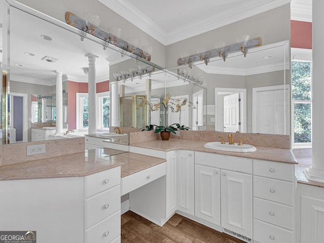 bathroom featuring crown molding, vanity with extensive cabinet space, wood-type flooring, and ornate columns