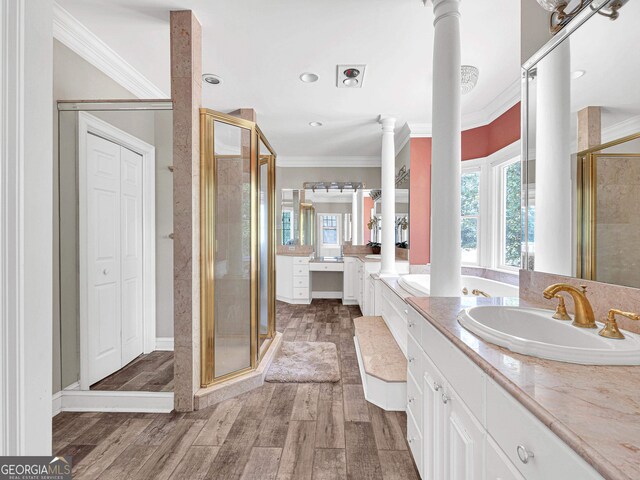 bathroom featuring decorative columns, a shower with shower door, wood-type flooring, and crown molding