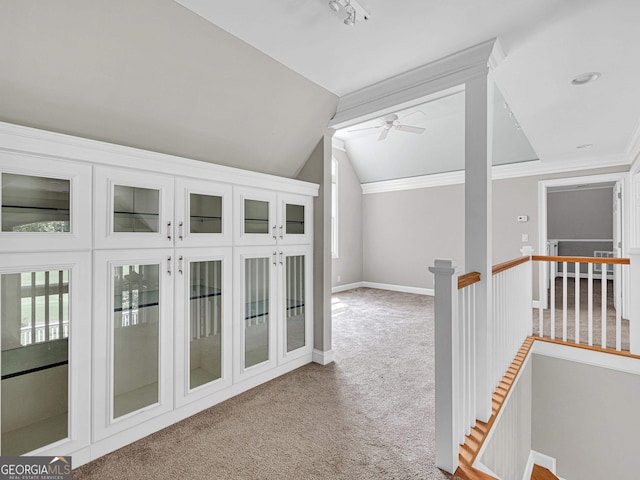 hallway with crown molding, light carpet, and lofted ceiling