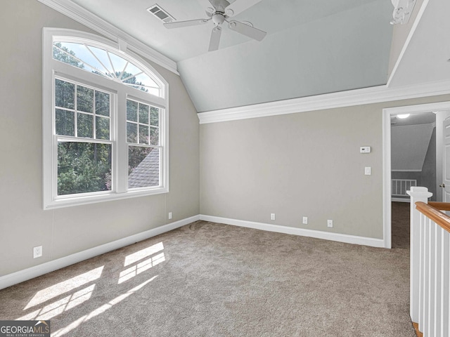 unfurnished room with ceiling fan, crown molding, light carpet, and vaulted ceiling