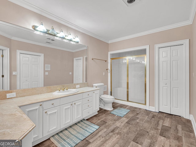 bathroom featuring crown molding, toilet, vanity, and wood-type flooring