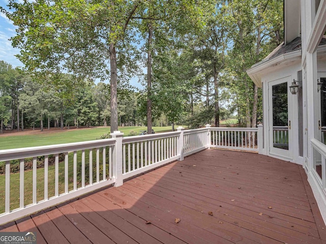 wooden terrace with a lawn