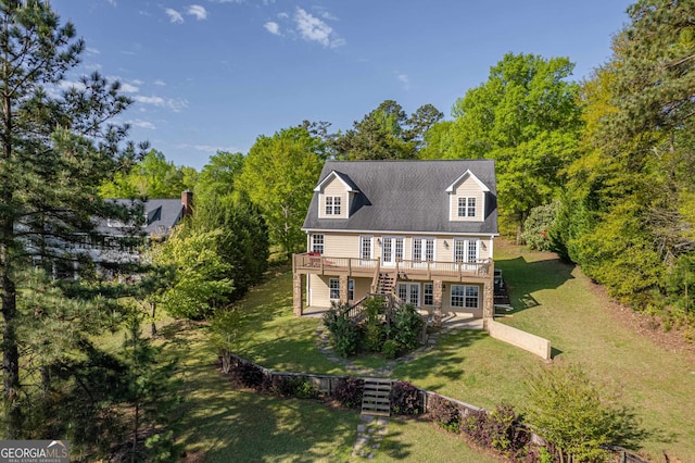 view of front of house with a deck and a front lawn