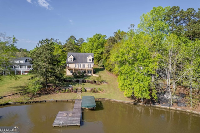 exterior space featuring a water view and a yard