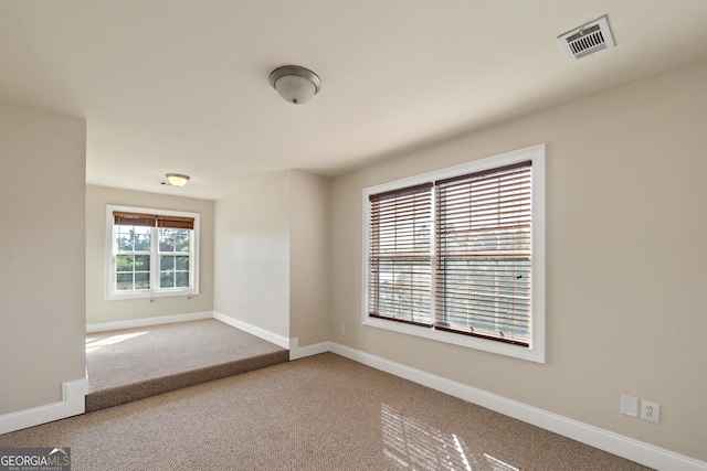 empty room featuring light carpet