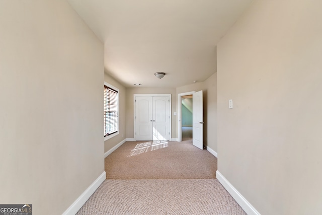 corridor with light colored carpet