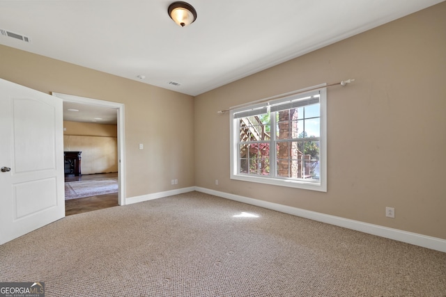 unfurnished room with light carpet