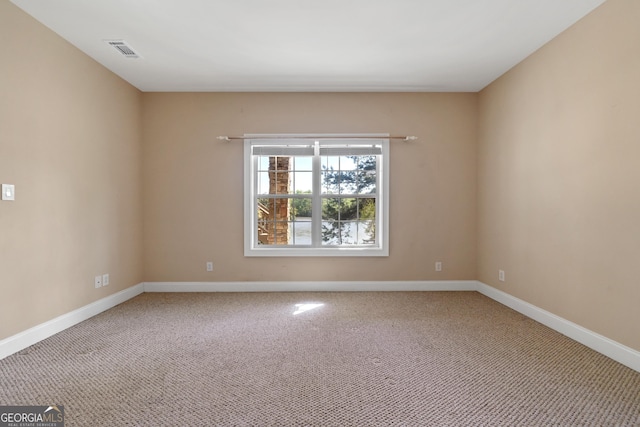 unfurnished room with light carpet