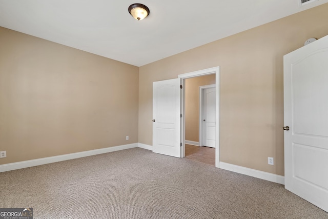 unfurnished bedroom with dark colored carpet