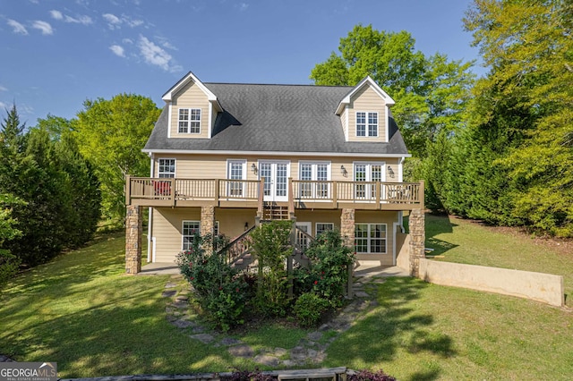 cape cod-style house with a front lawn and a wooden deck