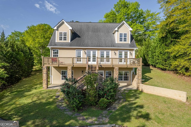 new england style home featuring a wooden deck and a front yard