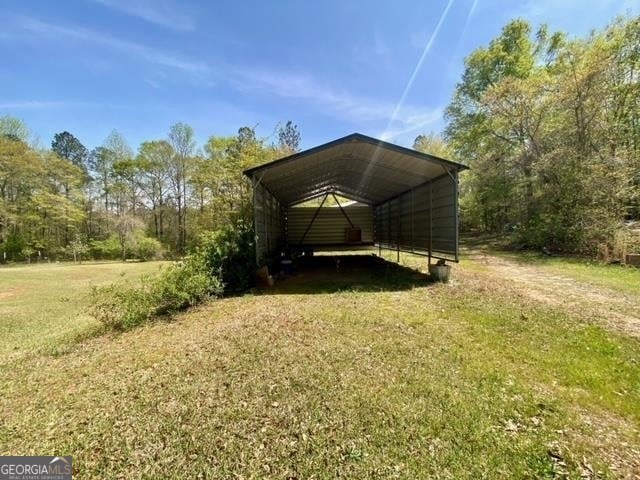 exterior space with a carport and a yard