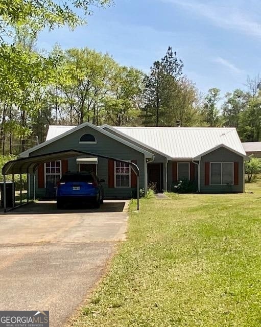 ranch-style house featuring a front yard and a carport