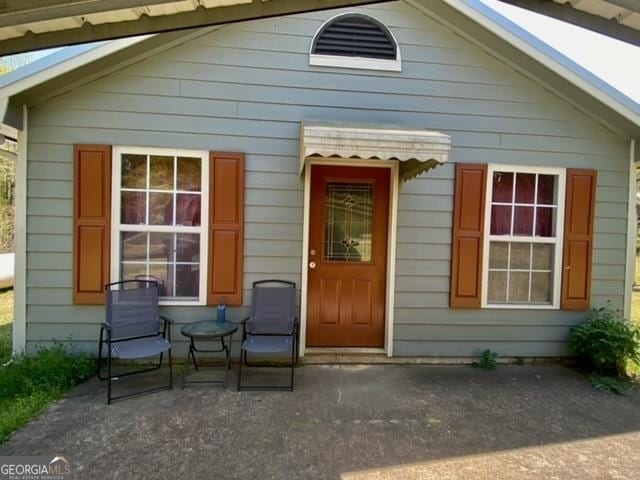 entrance to property with a patio